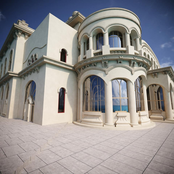 Cream-colored mansion with a rounded turret, arches, and tall windows; sits on a tiled terrace overlooking the sea.